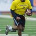 Gilvanni Johnson runs the ball for yards during the Victors Classic alumni football game at Michigan Stadium on Saturday. Melanie Maxwell I AnnArbor.com